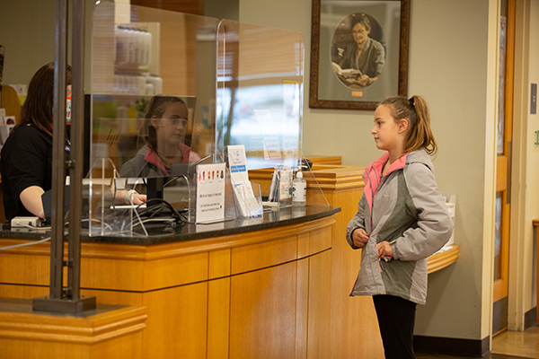 Young girl at help desk