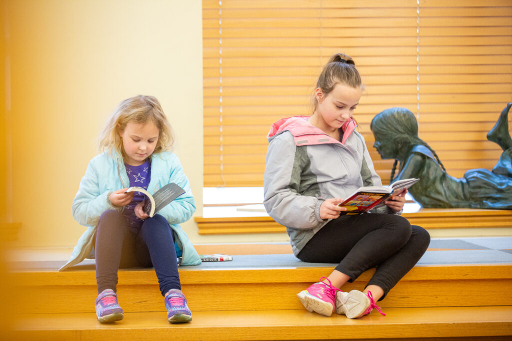 Young girls reading books